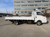 Side view of a reference single-cab electric dropside truck; markings and equipment may differ